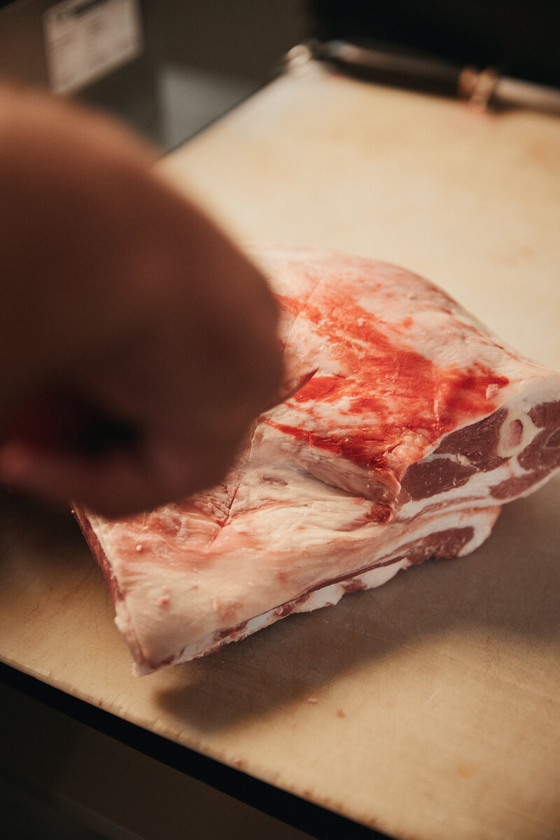 Close-up of meat preparation at Brian’s Butcher