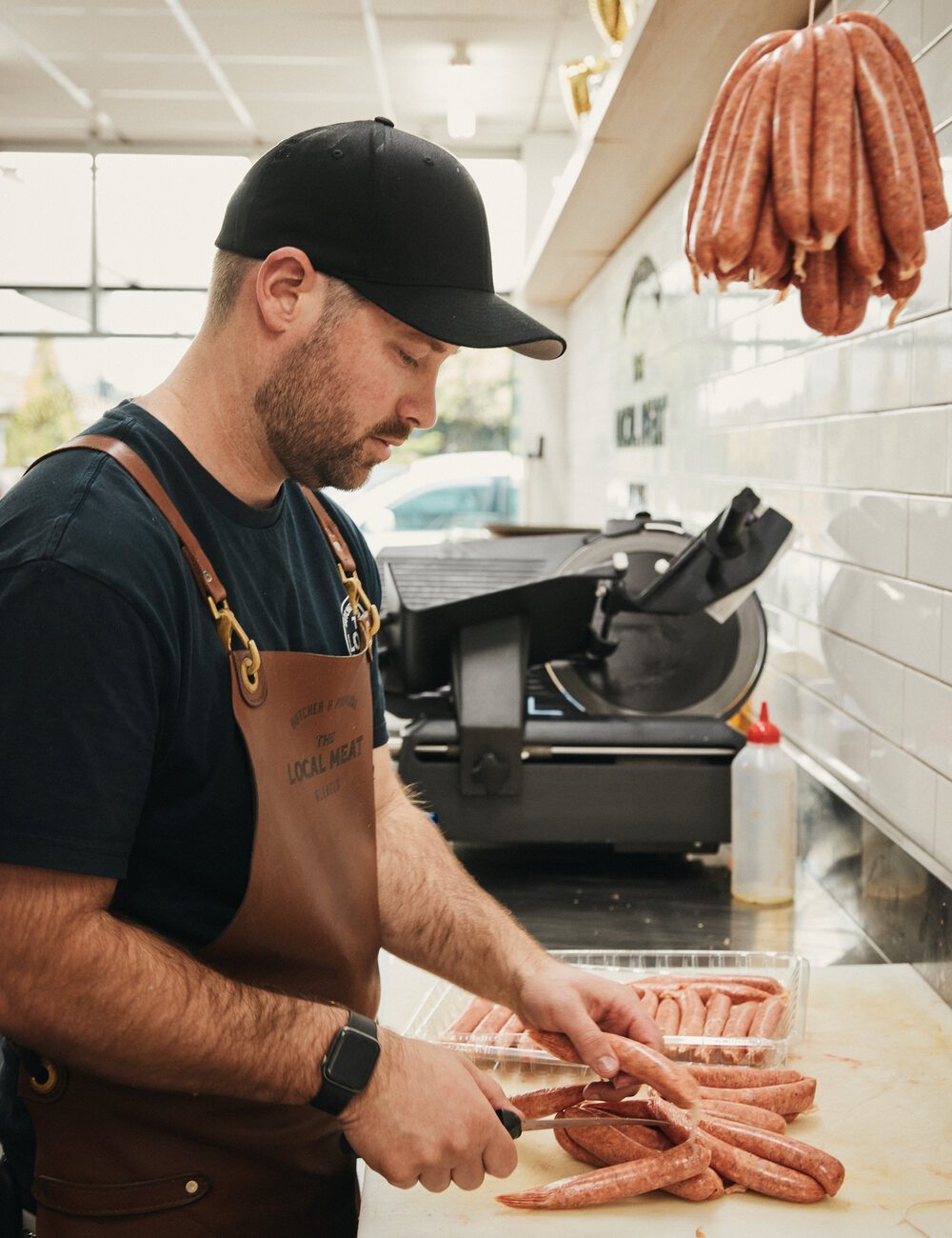 Independent butcher working in a shop